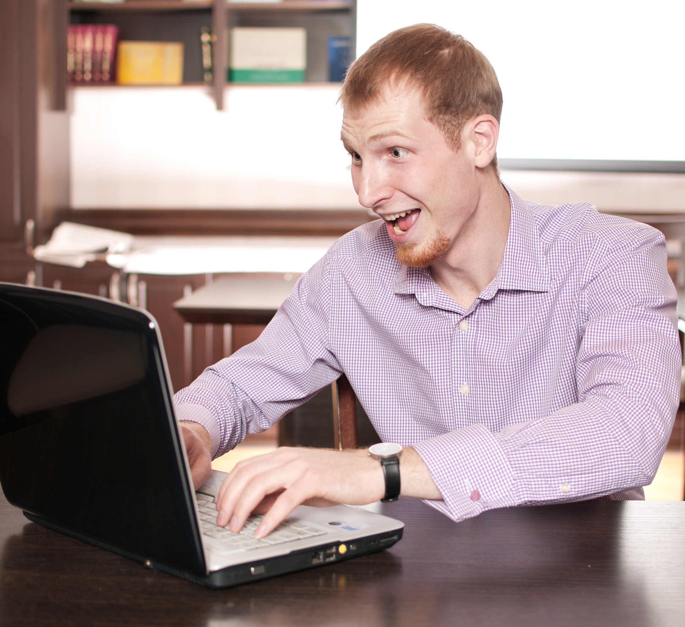 Man in office interior with laptop